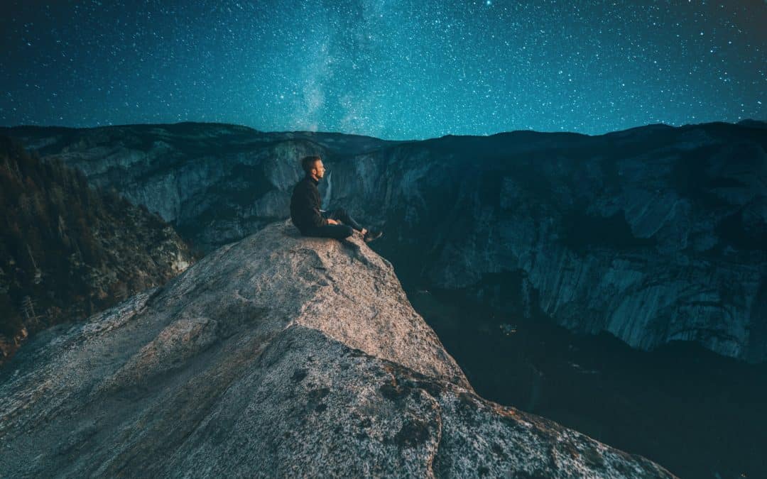 Man sitting on the rock at night